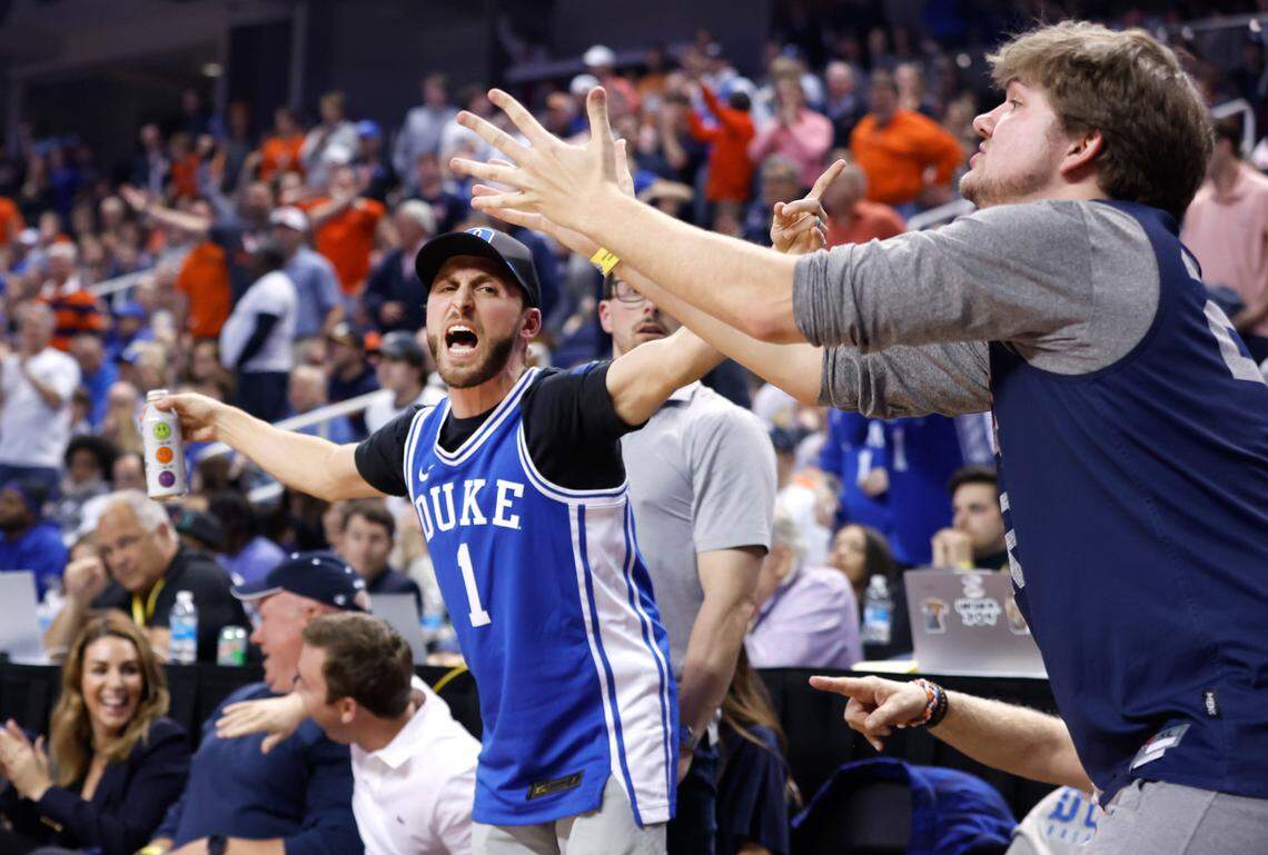 A Duke fan and Virginia fan have different reactions to the official’s call during the second half of Duke’s 59-49 victory over Virginia to win the ACC Men’s Basketball Tournament in Greensboro, N.C., Saturday, March 11, 2023.