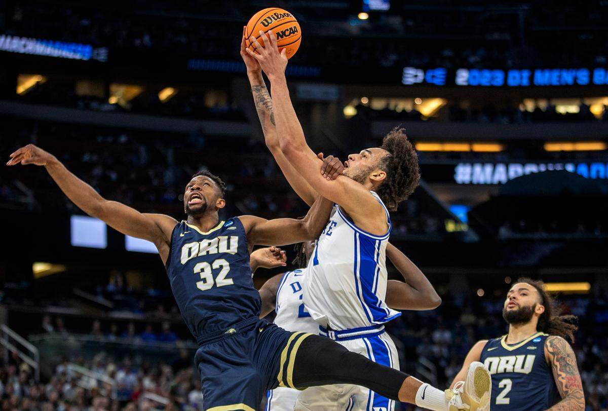 Duke’s Dereck Lively II (1) secures a defensive rebound over Oral Roberts’ Patrick Mwamba (32) during the first round of the NCAA Tournament on Thursday, March 16, 2023 at the Amway Center in Orlando, Fla.