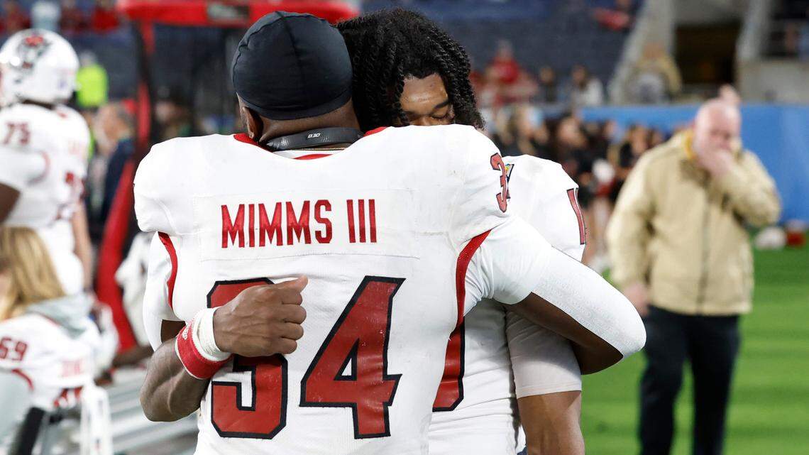 N.C. State’s KC Concepcion (10) and Delbert Mimms III (34) hug late in the fourth quarter during the second half of Kansas State’s 28-19 victory over N.C. State in the Pop-Tarts Bowl at Camping World Stadium in Orlando, Fla., Thursday, Dec. 28, 2023.