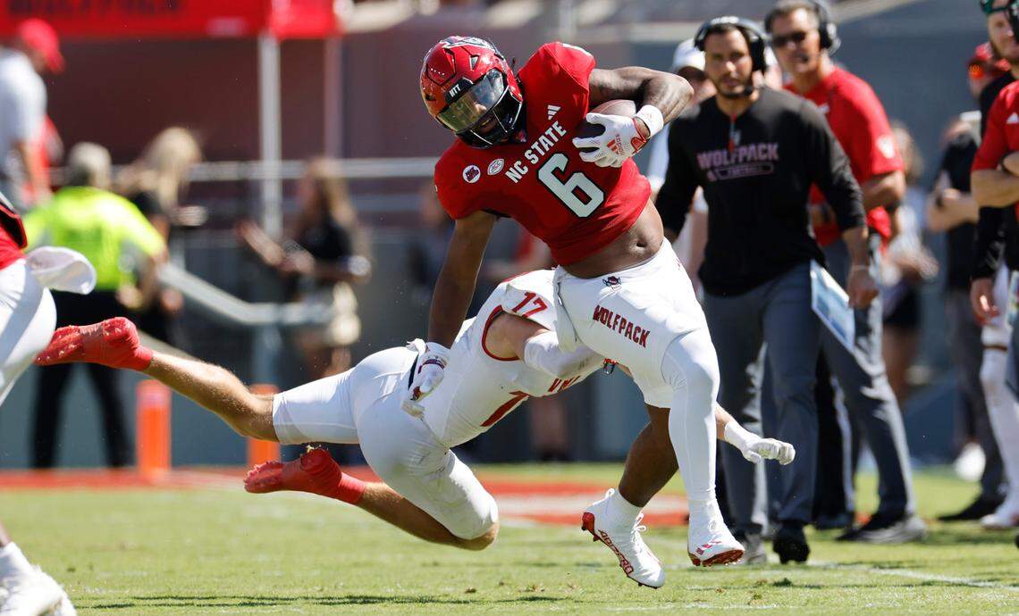N.C. State’s Trent Pennix (6) avoids the tackle by Virginia Military Institute defensive back Josh Knapp (17) during the first half of N.C. State’s game against VMI at Carter-Finley Stadium in Raleigh, N.C., Saturday, Sept. 16, 2023.