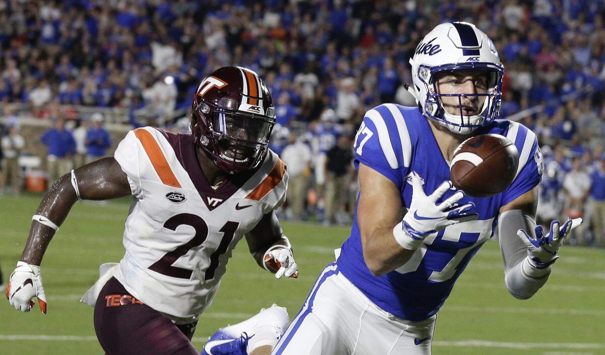 Duke’s Noah Gray (87) catches a touchdown pass while Virginia Tech’s Reggie Floyd (21) chases during the first half of an NCAA college football game in Durham, N.C., Saturday, Sept. 29, 2018. 