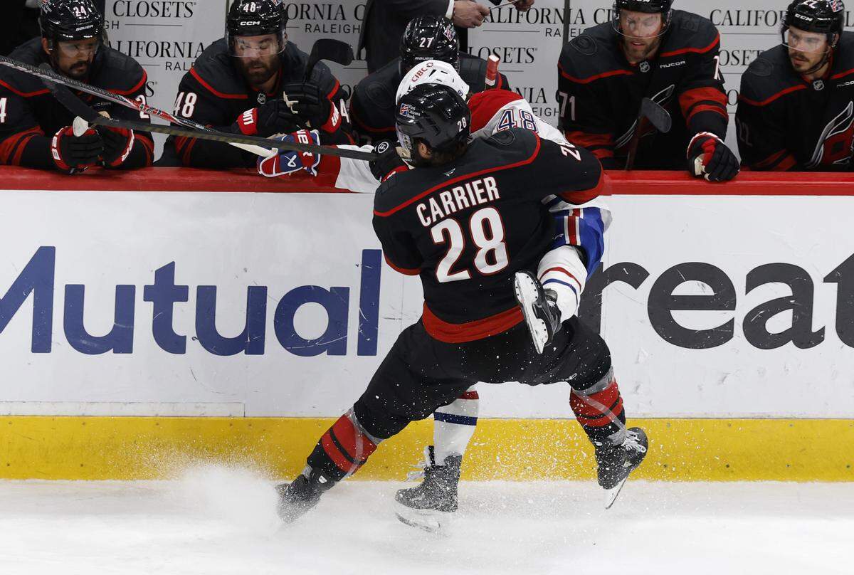 Carolina's William Carrier (28) checks Montréal's Lane Hutson (48) in the third period of the Hurricanes’ game against the Canadiens in game two of the Eastern Conference Finals at the Lenovo Center in Raleigh, N.C., Saturday, May 23, 2026.