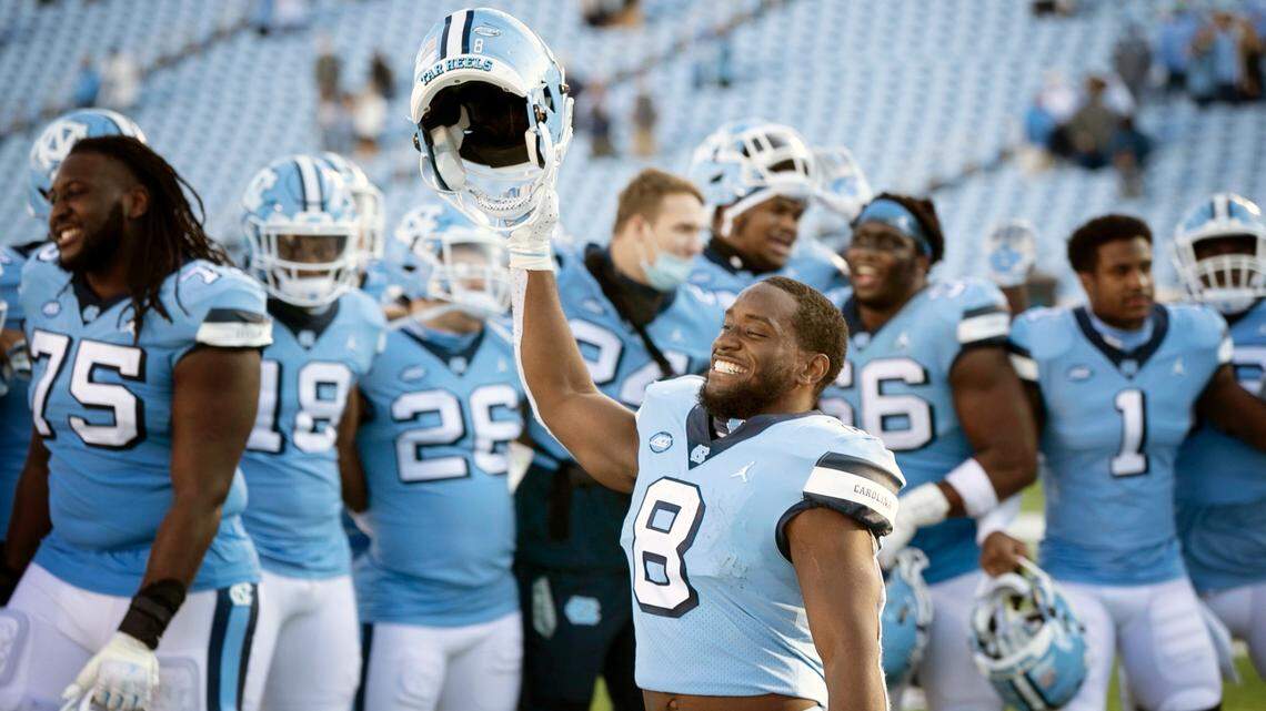North Carolina’s Michael Carter (8) and his teammates celebrate their 59-53 victory over Wake Forest at Kenan Stadium on Saturday, November 14, 2020 in Chapel Hill, N.C.