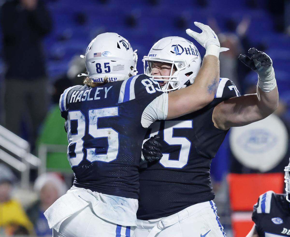 Duke’s Jeremiah Hasley celebrates with teammate Bruno Fina after scoring a touchdown during the second half of the Blue Devils’ 49-32 win over Wake Forest on Saturday, Nov. 29, 2025, at Wallace Wade Stadium in Durham, N.C.