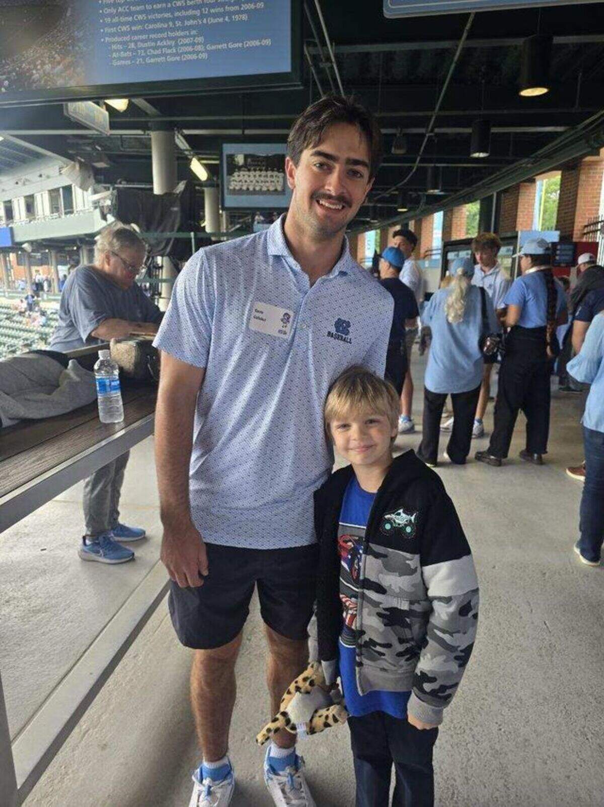 North Carolina infielder Gavin Gallaher takes a photo with David Hill, 6, during an event at Boshamer Stadium in Chapel Hill, North Carolina.