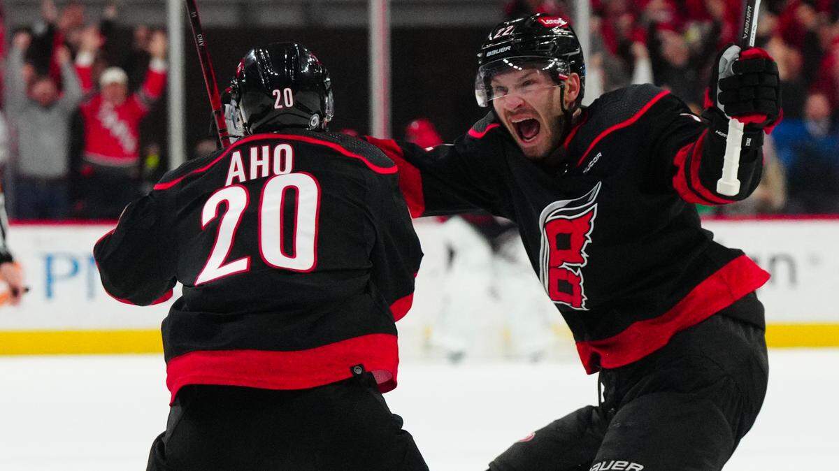 Feb 22, 2024; Raleigh, North Carolina, USA; Carolina Hurricanes center Sebastian Aho (20) is congratulated by defenseman Brett Pesce (22) after his goal against the Florida Panthers during the third period at PNC Arena. Mandatory Credit: James Guillory-USA TODAY Sports