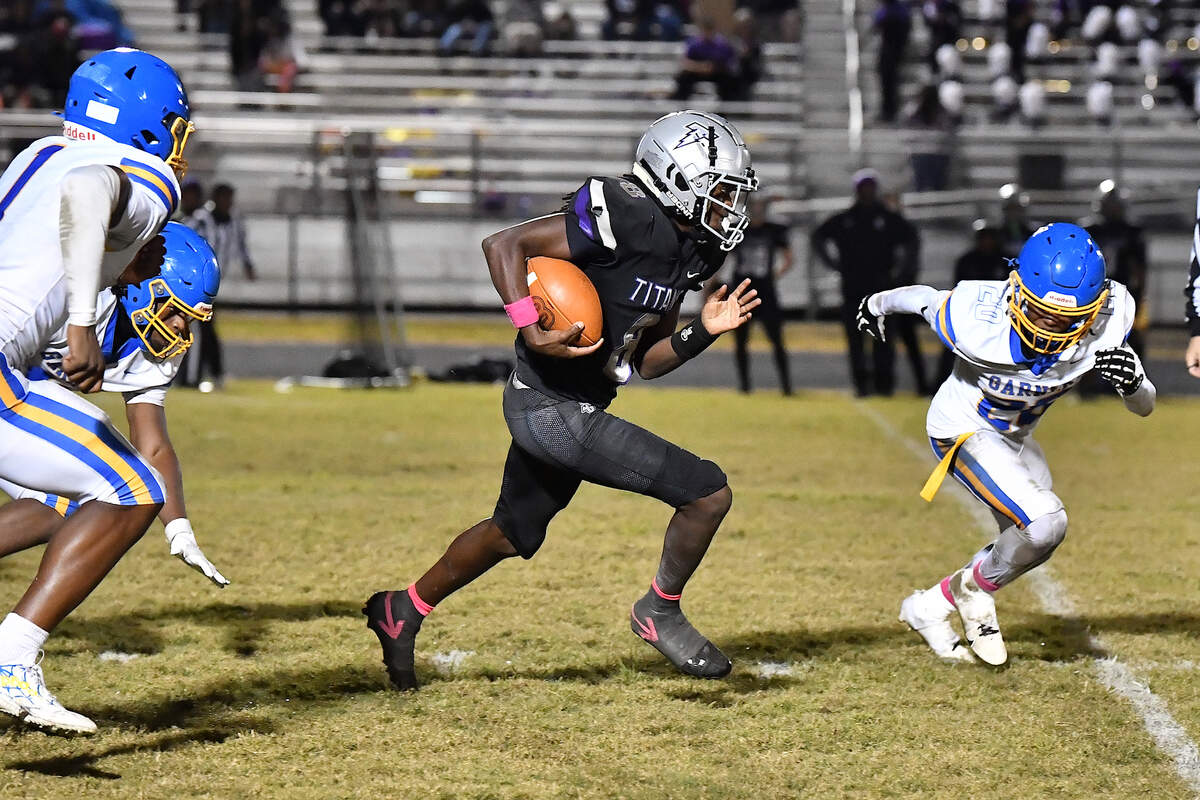 South Garner quarterback Chase Hardy (8) sprints for the first down against Garner during the second half. The South Garner Titans and the Garner Trojans met in a conference football game in Raleigh, N.C. October 17, 2025