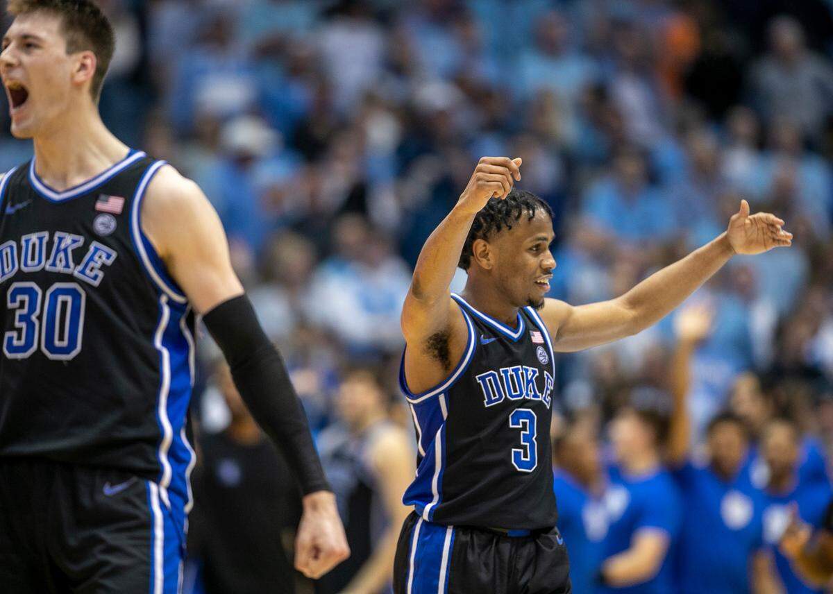 Duke’s Jeremy Roach (3) and Kyle Filipowski (30) react as the final seconds expire, securing the Blue Devil’s 67-52 victory over North Carolina on Saturday, March 4, 2023 at the Smith Center in Chapel Hill, N.C.