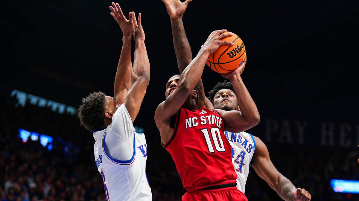 North Carolina State Wolfpack guard Marcus Hill (10) goes up for a shot against Kansas Jayhawks guard Rylan Griffen (6) and forward KJ Adams Jr. (24) during the first half at Allen Fieldhouse.
