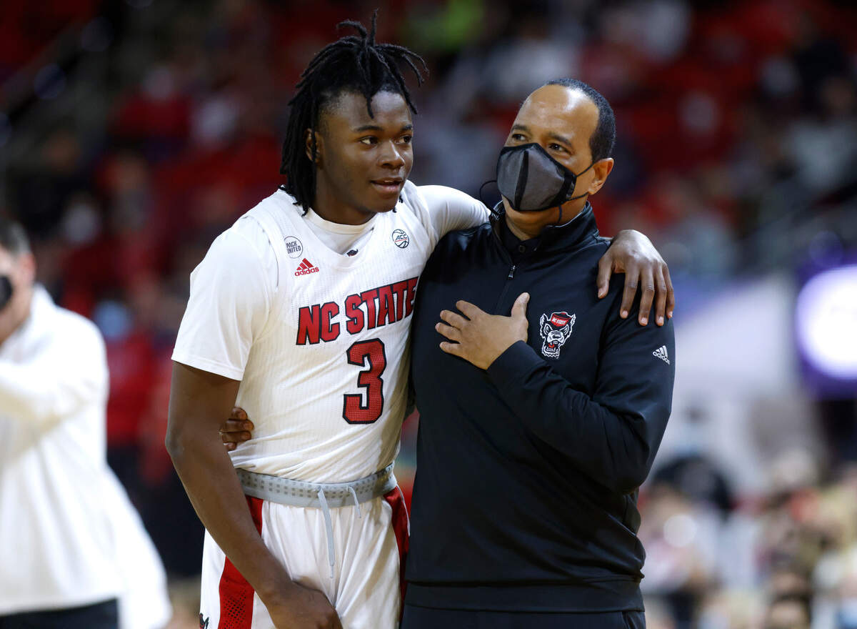 N.C. State head coach Kevin Keatts talks with Cam Hayes (3) during the second half of Clemson’s 70-65 victory over N.C. State at PNC Arena in Raleigh, N.C., Saturday, January 8, 2022.