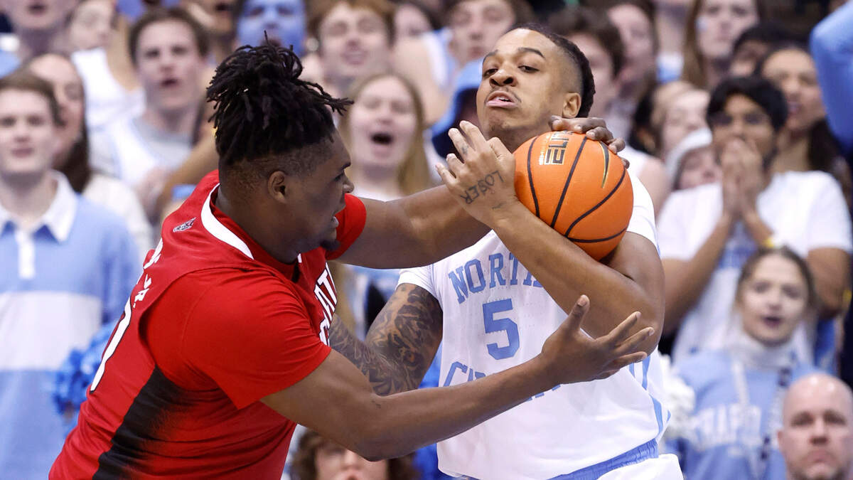 North Carolina’s Armando Bacot (5) steals the ball from N.C. State’s D.J. Burns Jr. (30) during the first half of N.C. State’s game against UNC at the Smith Center in Chapel Hill, N.C., Saturday, Jan. 21, 2023.