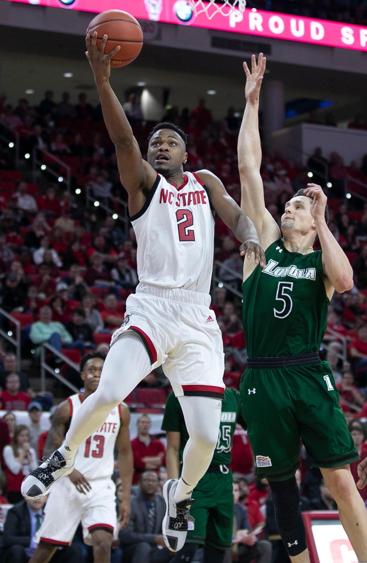 N.C. State’s Torin Dorn (2) drives to the basket against Loyola’s James Fives (5) during the first half on Friday, December 28, 2018 at the PNC Arena in Raleigh, N.C.