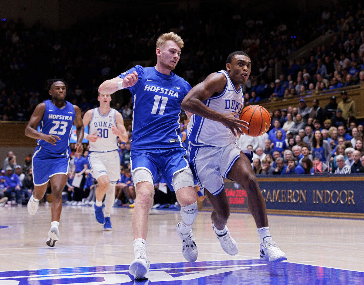 Duke’s Jaylen Blakes pushes the ball past Hofstra’s Jacco Fritz during the second half of the Blue Devils’ 89-68 win on Tuesday, Dec. 12, 2023, at Cameron Indoor Stadium in Durham, N.C.