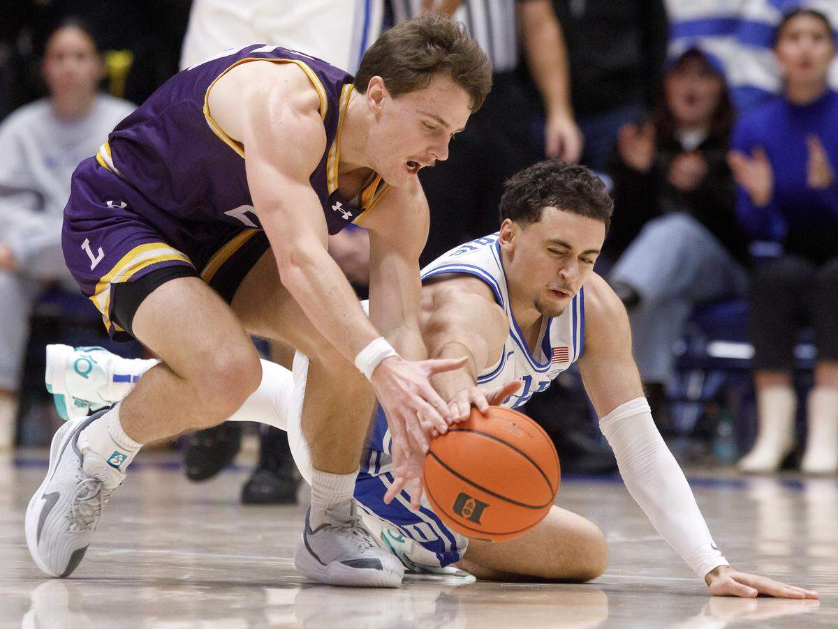 Lipscomb's Titas Sargiunas and Duke’s Darren Harris dive after a loose ball during the second half of the Blue Devils’ 97-73 win on Tuesday, Dec. 16, 2025, at Cameron Indoor Stadium in Durham, N.C.