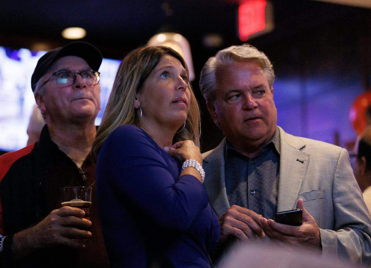Michele Morrow, Republican candidate for NC superintendent of public instruction, watches election night coverage with supporters at Sophie’s Grill and Bar on Tuesday, Nov. 5, 2024, in Cary, N.C.