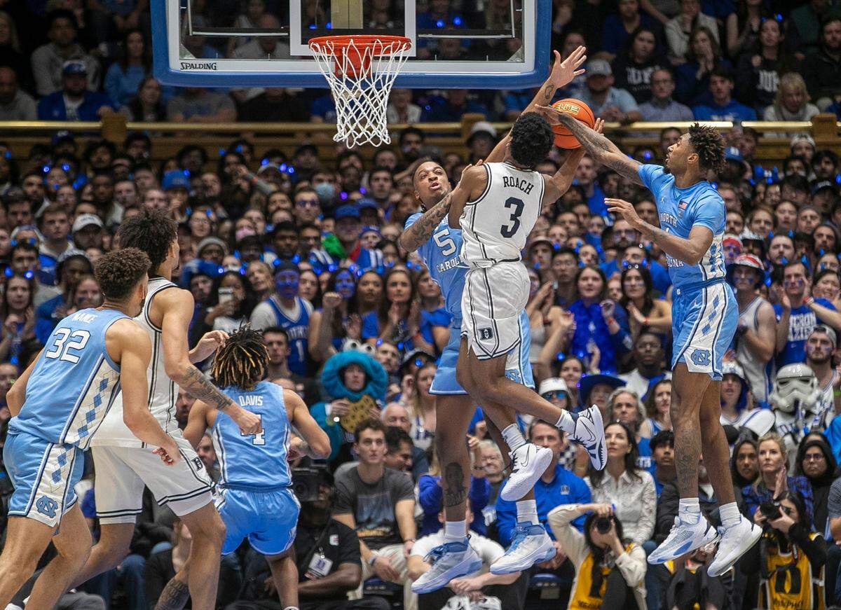 Duke’s Jeremy Roach (3) drives to the basket between North Carolina’s Leaky Black (1) and Armando Bacot (5) in the second half on Saturday, February 4, 2023 at Cameron Indoor Stadium in Durham, N.C. Roach lead all scores with 20 points in the Blue Devils’ 63-57 victory.