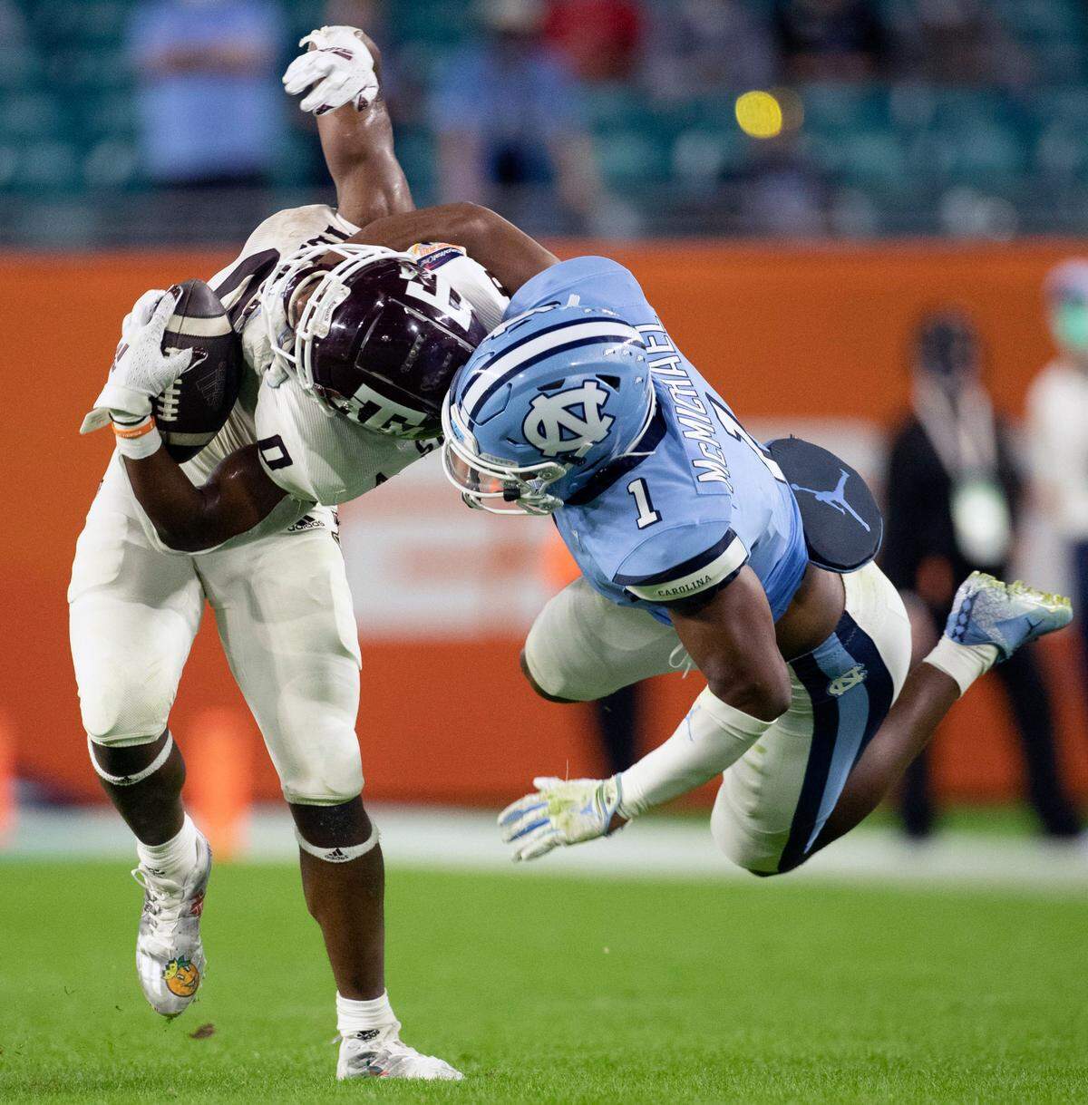 North Carolina’s Kyler McMichael (1) stops Texas A&M’s Ainias Smith (0) after a 14-yard pass completion in the third quarter during the Capital One Orange Bowl on Saturday, January 2, 2021in Miami Gardens, Florida.