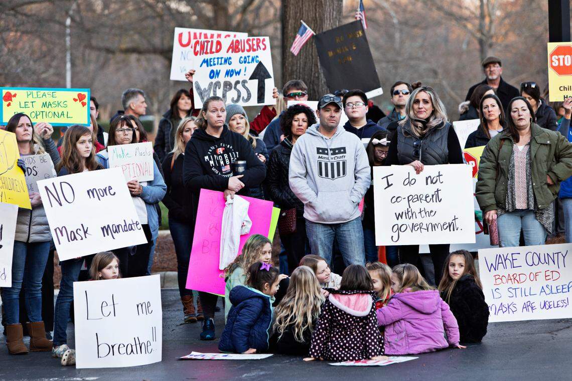 A crowd of around 100 people rallied outside Tuesday’s Wake County school board meeting in Cary Feb. 15, 2022, demanding that the district immediately stop mandating that students wear masks. Event participants want the school board to vote Tuesday or to call a special meeting by next week to vote on making masks optional.