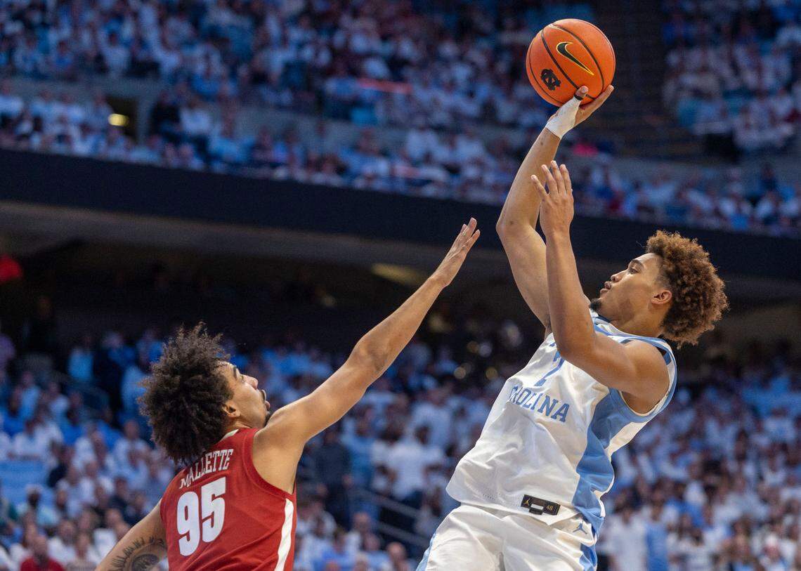 North Carolina guard Seth Trimble (7) puts up a shot against Alabama guard Houston Mallette (95) in the second half on Wednesday, December 4, 2024 at the Smith Center in Chapel Hill, N.C. Trimble scored 12 points in the Tar Heels’ 94-79 loss.