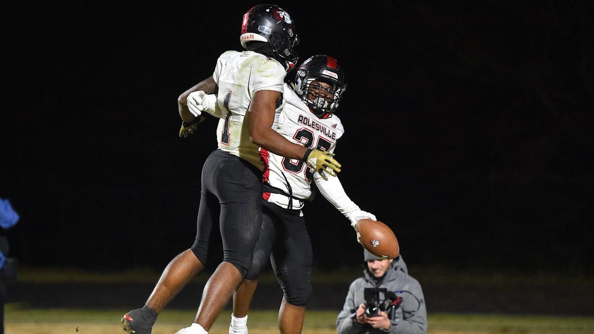 Rolesville’s Caleb Jarvis (35) celebrates with Tamarcus Cooley (1) after his touchdown against Wake Forest during the fourth quarter. The Rolesville Rams and the Wake Forest Cougars met in the NCHSAA 4A third round playoff game in Wake Forest, NC on November 18, 2022