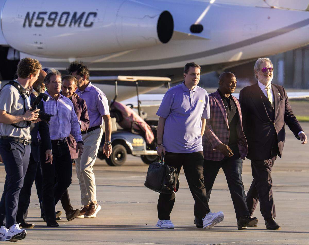 Will Wade walks from a private plane surrounded by LSU officials on Thursday, March 26, 2026 at the BTR Jet Center in Baton Rouge, Louisiana. 