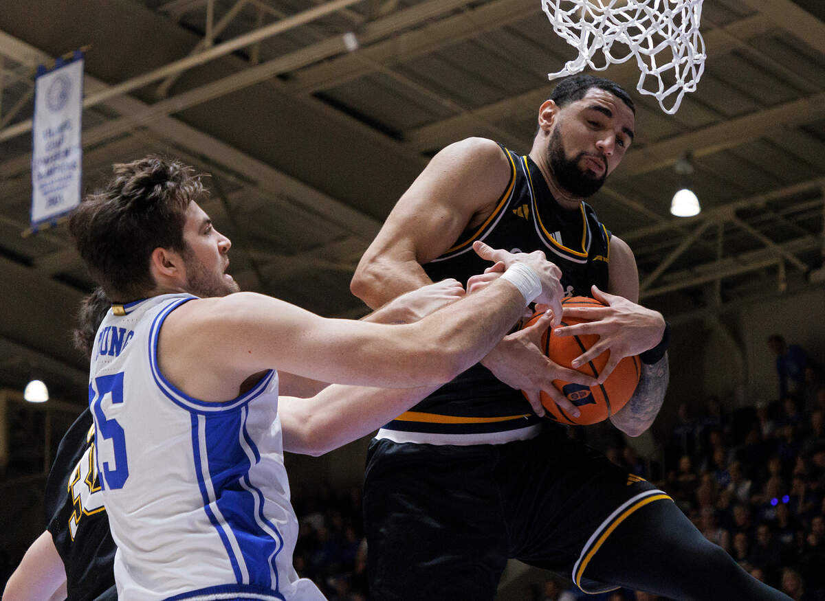La Salle’s Daeshon Shepherd grabs a rebound away from Duke’s Ryan Young during the first half of the Blue Devils’ game on Tuesday, Nov. 21, 2023, at Cameron Indoor Stadium in Durham, N.C.