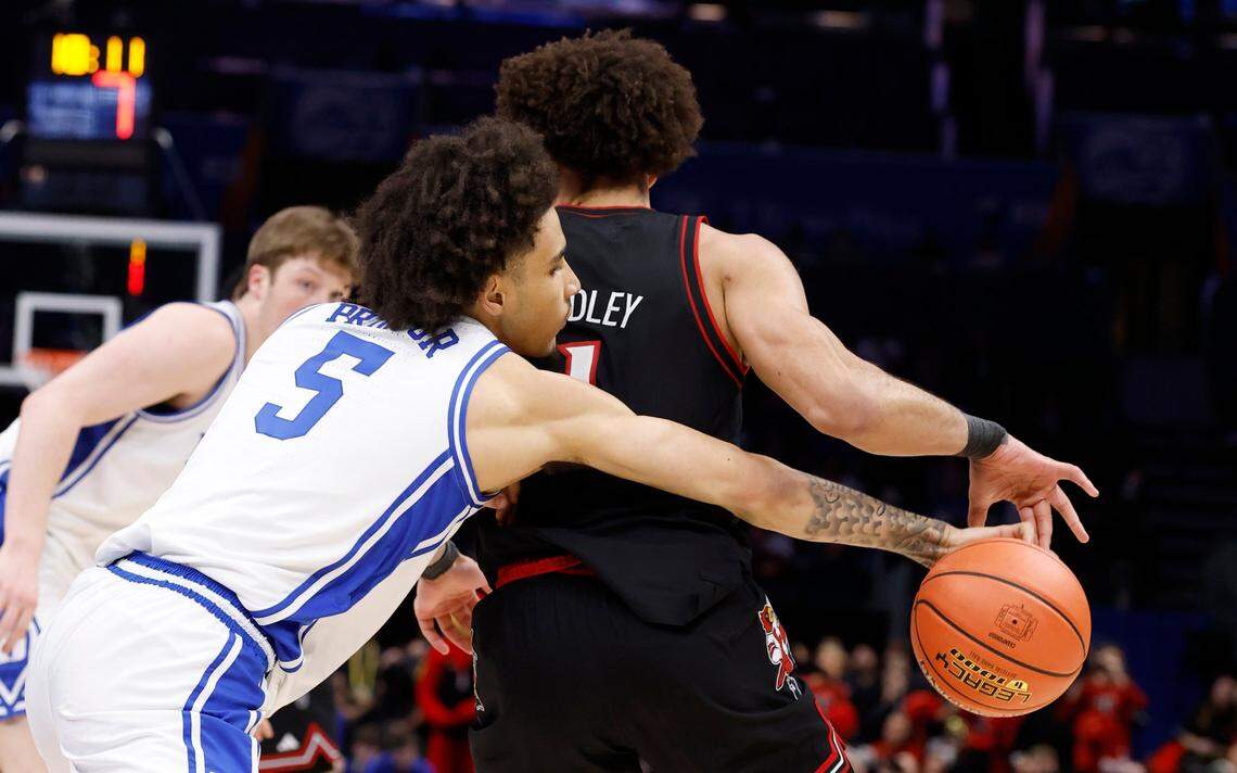 Duke’s Tyrese Proctor (5) steals the ball from Louisville’s J’Vonne Hadley (1) during the first half of Duke’s game against Louisville in the finals of the 2025 ACC Men’s Basketball Tournament at the Spectrum Center in Charlotte, N.C., Saturday, March 15, 2025.