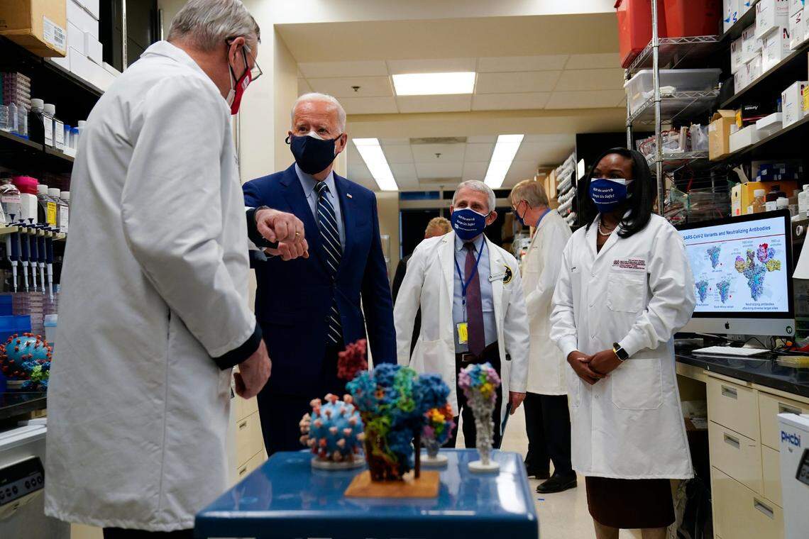 President Joe Biden greets Barney Graham, left, as he visits the Viral Pathogenesis Laboratory at the National Institutes of Health, Thursday, Feb. 11, 2021, in Bethesda, Md. From left, Graham, Biden, Dr. Anthony Fauci, director of the National Institute of Allergy and Infectious Diseases, and Kizzmekia Corbett.