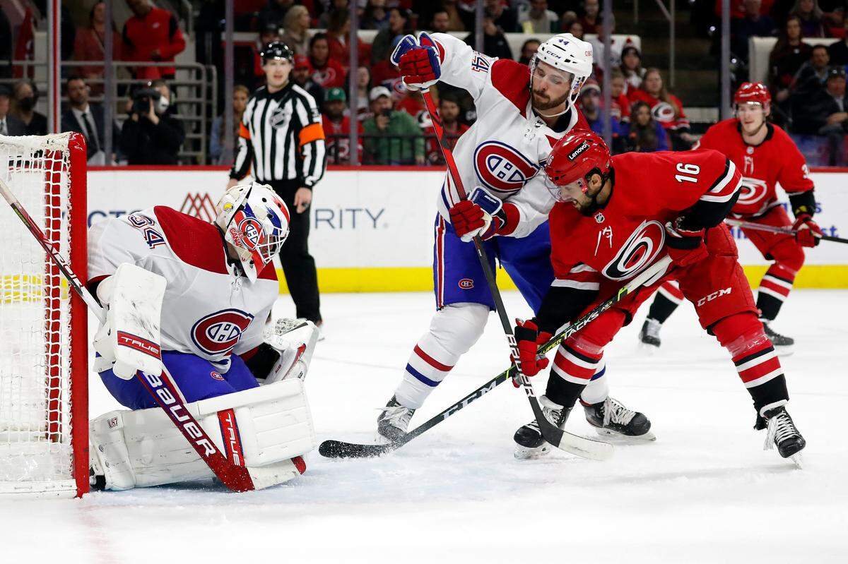 Carolina Hurricanes’ Vincent Trocheck (16) battles works against Montreal Canadiens’ Joel Edmundson (44) and has his shot blocked by Canadiens goaltender Jake Allen (34) during the second period of an NHL hockey game in Raleigh, N.C., Thursday, March 31, 2022. (AP Photo/Karl B DeBlaker)