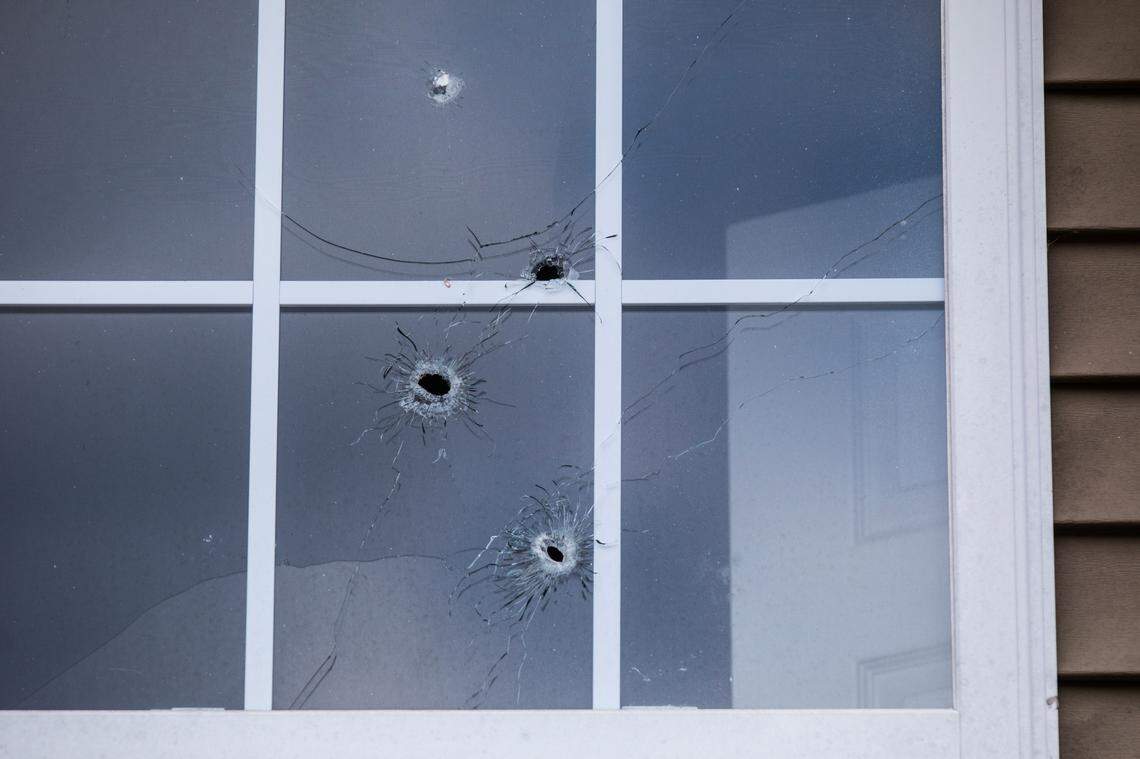 Bullet holes riddle a second floor window of an apartment duplex on McNeil Lane in Durham Tuesday, July 16, 2019. An 8-year-old girl was shot and an 11-year-old boy injured early Monday morning after bullets were fired into their home early Monday morning on McNeil Lane in Durham.