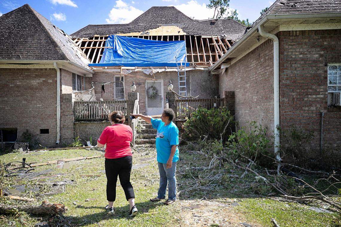 Homeowner Brenda Wilson, right, shows Cally Edwards of the American Red Cross the damage to the rear of her home on Woodard Road in rural Bertie County on Tuesday, August 4, 2020 near Windsor, N.C. A tornado from Hurricane Isaias moved through Bertie County early Tuesday morning damaging homes and causing at least two deaths.