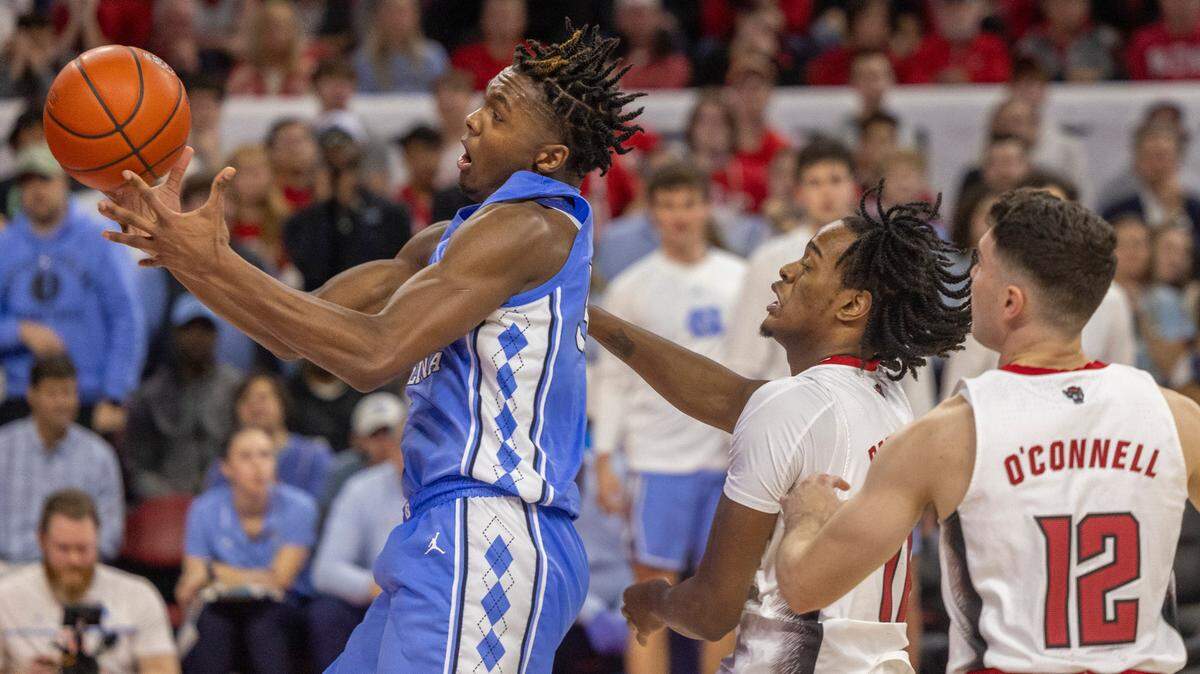 North Carolina’s Harrison Ingram (55) goes after an offensive rebound ahead of N.C. State’s Dennis Parker Jr. (11) in the second half on Wednesday, January 10, 2024 at PNC Arena in Raleigh, N.C. Ingram collected a record 19 rebounds in the Tar Heels’ victory.