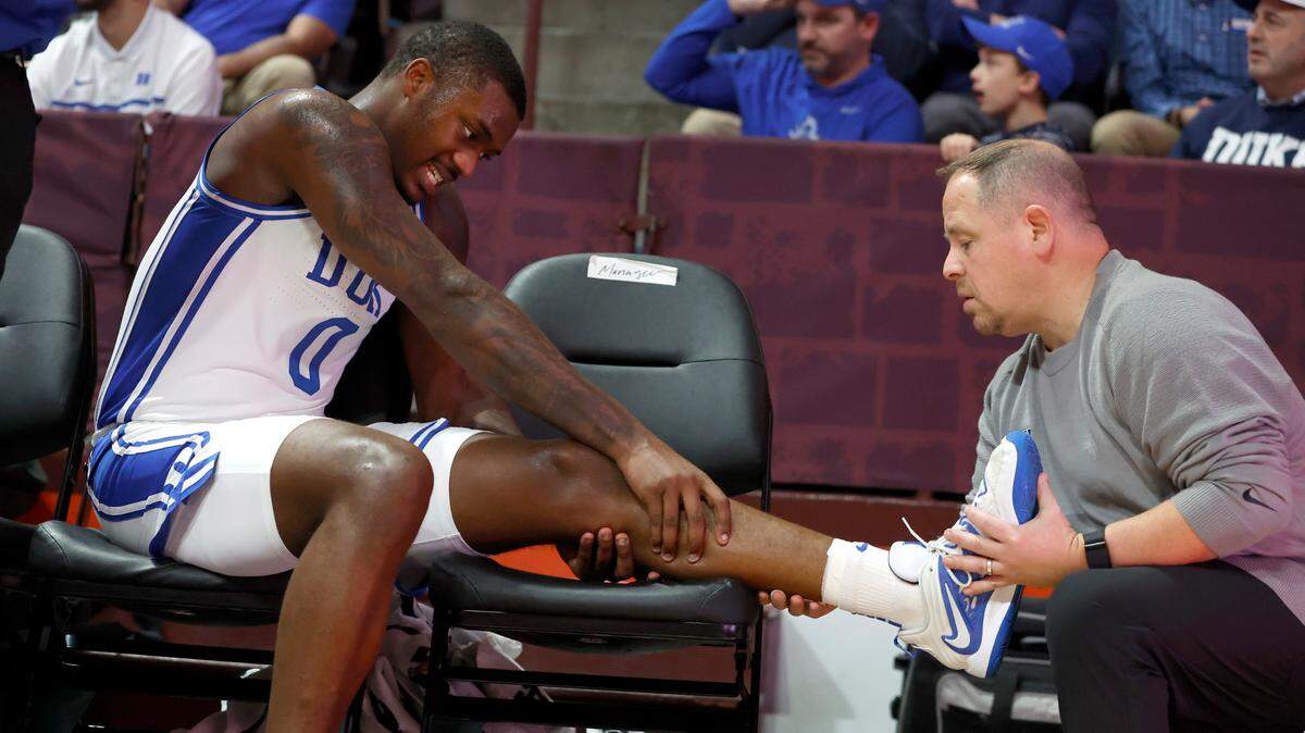 Duke trainer Jose Fonseca checks on the injury to Dariq Whitehead during the second half of Virginia Tech’s 78-75 victory over Duke at Cassell Coliseum in Blacksburg, VA., Monday, Jan. 23, 2023. Whitehead would be helped to the locker room a little bit later.
