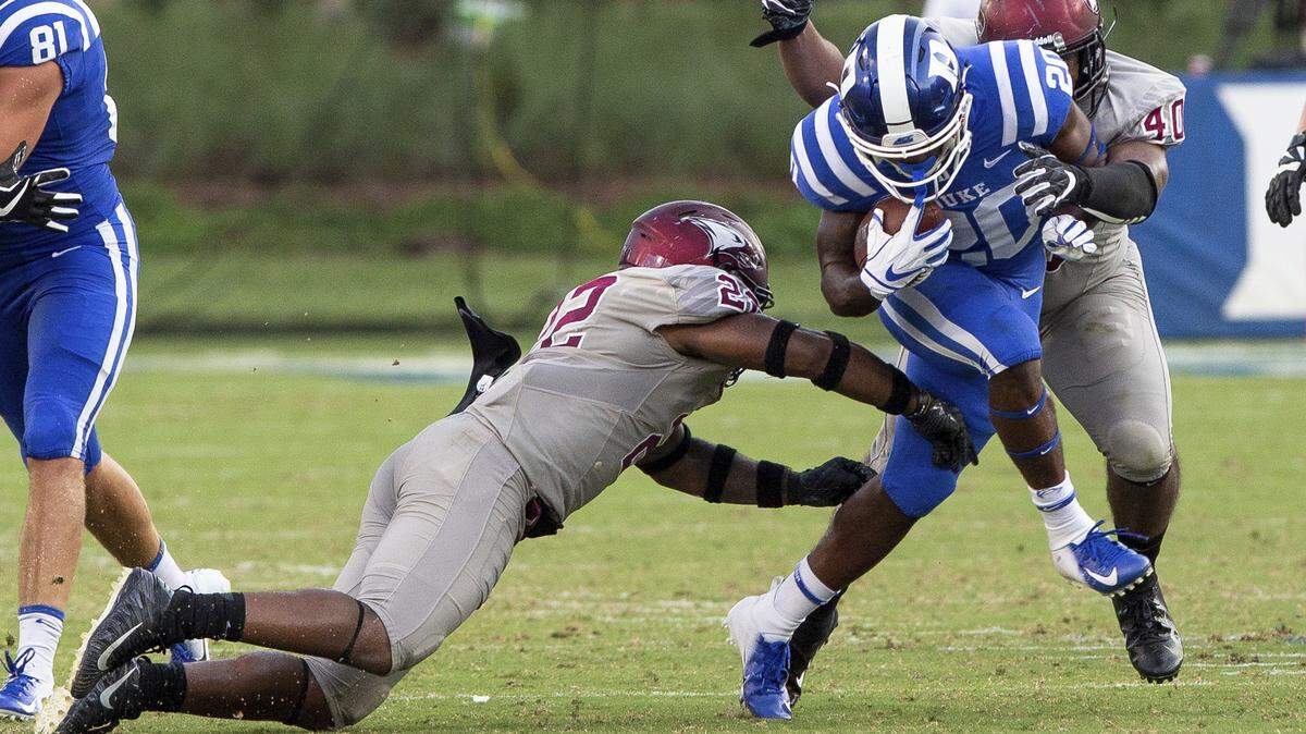 Duke’s Marvin Hubbard III, middle, carries the ball as N.C. Central’s Davanta Reynolds, left, and Patrick Connor, far right, reach for a tackle during the second half of the Blue Devils 55-13 win over the Eagles.