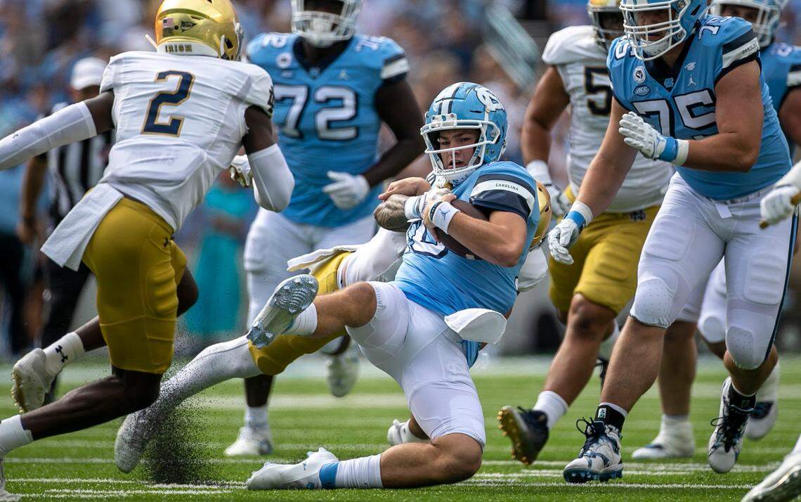 Notre Dame’s Marist Liufau (8) stops North Carolina quarterback Drake Maye (10) after a 15-yard again in the first quarter on Saturday, September 24, 2022 at Kenan Stadium in Chapel Hill, N.C.