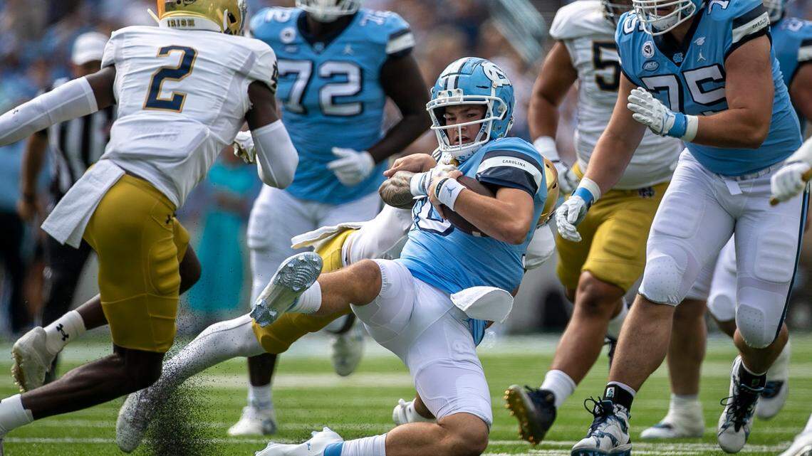 Notre Dame’s Marist Liufau (8) stops North Carolina quarterback Drake Maye (10) after a 15-yard again in the first quarter on Saturday, September 24, 2022 at Kenan Stadium in Chapel Hill, N.C.
