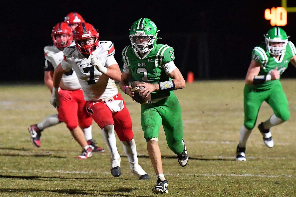 Cary quarterback Nick Grena (3) runs for the first down against Middle Creek's Davis Prichard (7) during the second half. The Cary Imps and the Middle Creek Mustangs met in a conference football game in Cary, N.C. on October 24, 2025