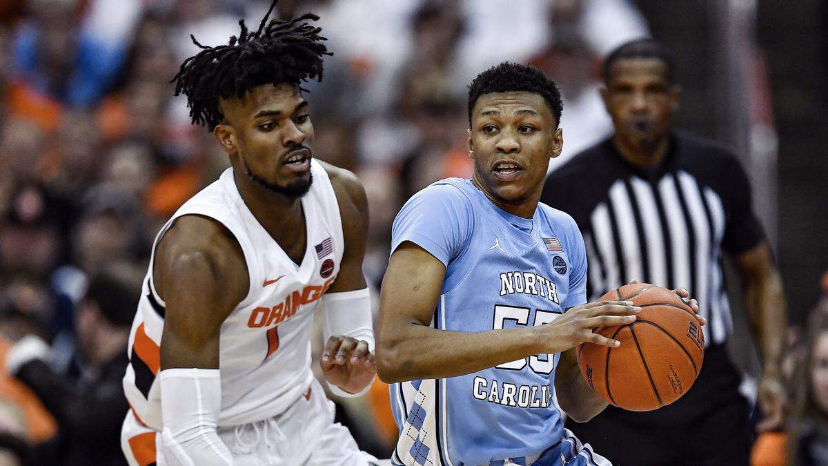 North Carolina guard Christian Keeling, right, is defended by Syracuse forward Quincy Guerrier during the second half of an NCAA college basketball game in Syracuse, N.Y., Saturday, Feb. 29, 2020. North Carolina defeated Syracuse 92-79.