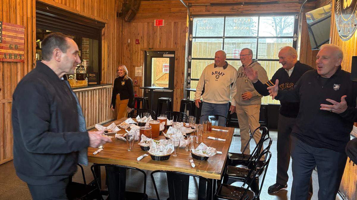 Mike Krzyzewski, left, is greeted by his former Army player Pat Harris, right, along with, right to left, Bob Brown, Marty Coyne and Matt Brown at a gathering of Krzyzewski’s former players in Highland Falls, N.Y., on Tuesday. Army honored Krzyzewski before Tuesday night’s game between his two former schools.