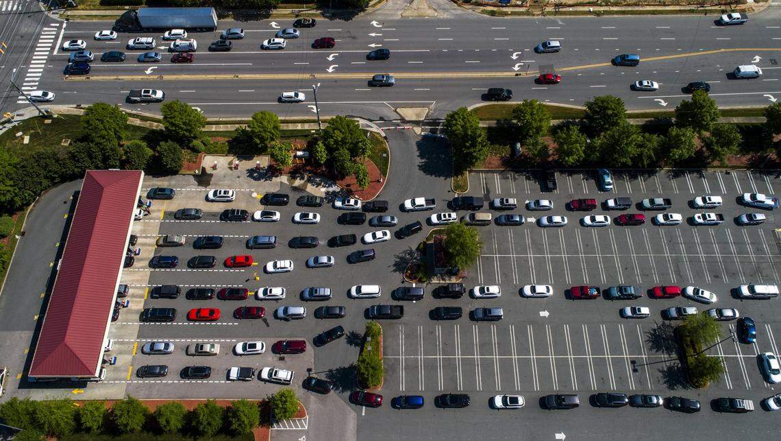 Vehicles wait in lines at the Costco in Raleigh Thursday, May 13, 2021. Operators of the Colonial Pipeline say they began the process of moving fuel through the 5,500-mile pipeline again at about 5 p.m. Wednesday, six days after it was shut down because of a cyberattack.