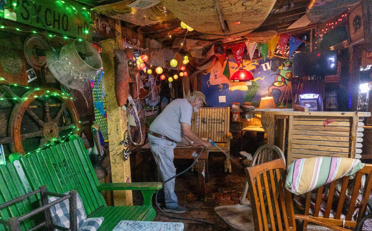 Danny McLaughlin cleans ups inside Fat Pelican bar as floodwaters recede in Carolina Beach on Tuesday, Sept. 17, 2024 after an unnamed storm dropped as much as 18 inches of rain in southeastern North Carolina over a 72-hour period. Flood Levels in Carolina Beach rivaled that of Hurricane Floyd in 1999.