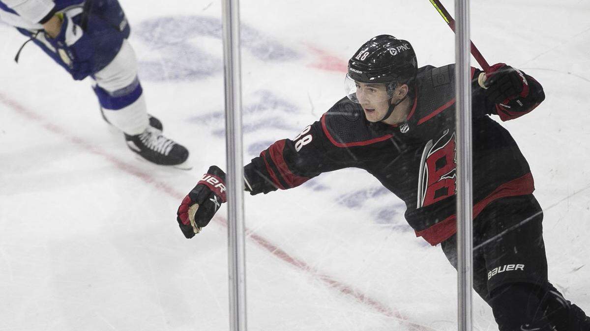 Carolina Hurricanesí Martin Necas (88) reacts after scoring on Tampa Bay goalie Andrei Vasilevskiy (88) to give the Hurricanes a 1-0 sudden death overtime victory in their season home opener on Thursday, January 28, 2021 at PNC Arena in Raleigh, N.C.