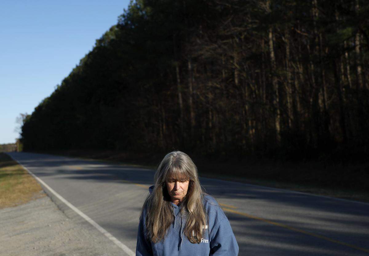 Lisa Higgins stands along a rural Pitt County road in November. A Highway Patrol officer sped from the intersection on Aug. 22, 2020, trying to catch up to a suspected drunk driver, but lost control of his car and wrecked, killing Lisa's son, Michael Higgins.