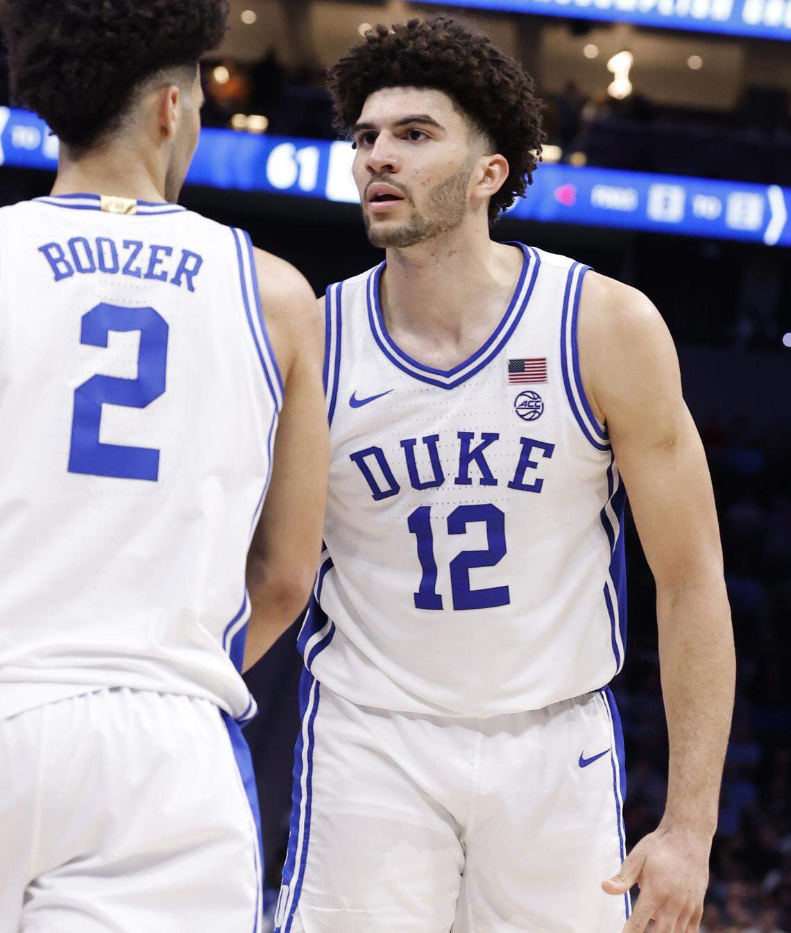 Duke’s Cameron Boozer (12) talks to Cayden Boozer (2) in the second half of Duke’s 80-79 victory over Florida State in the quarterfinals of the 2026 ACC Men’s Basketball Tournament at the Spectrum Center in Charlotte, N.C., Thursday, March 12, 2026.