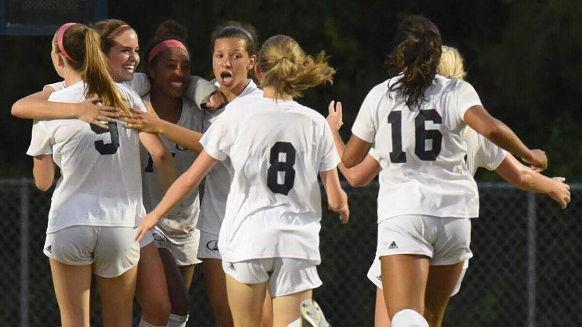 Heritage’s Mackenzie Libscomb (11) celebrates with her teammates after scoring the double-overtime winner in 1 a-0 win over Hoggard in the East Regional, Tuesday May 21, 2019, in Wilmington, N.C.
