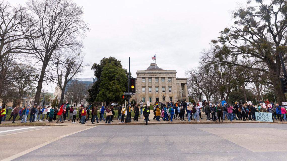 Hundreds of demonstrators march around the perimeter of the North Carolina State Capitol in Raleigh on Wednesday, Feb. 5, 2024, to protest the Trump administration and Elon Musk.