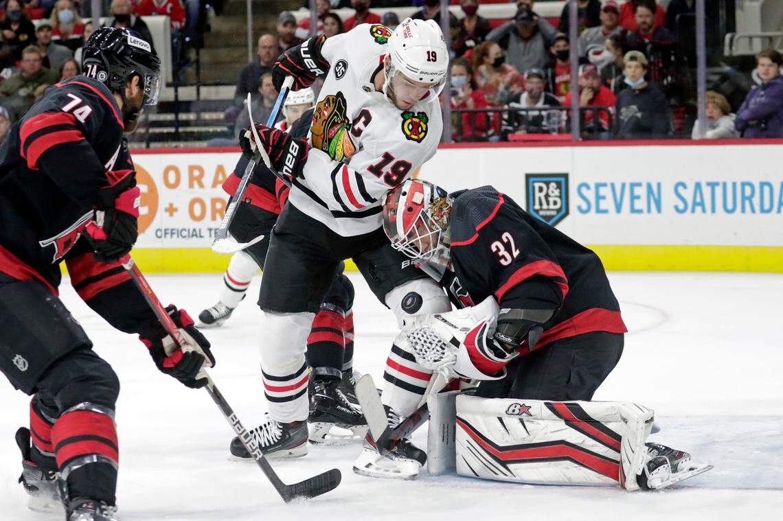 Carolina Hurricanes defenseman Jaccob Slavin (74) and goaltender Antti Raanta (32) defend against Chicago Blackhawks center Jonathan Toews (19) during the first period of an NHL hockey game Friday, Oct. 29, 2021, in Raleigh, N.C. (AP Photo/Chris Seward)