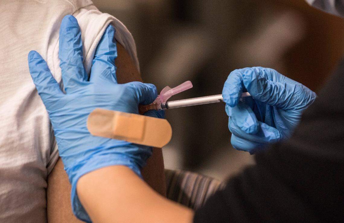Swati Amin gives a COVID-19 vaccine to Daniel Carbajal at the NC Heart and Vascular Hospital at UNC REX in Raleigh, N.C. on Thursday, December 17, 2020.
