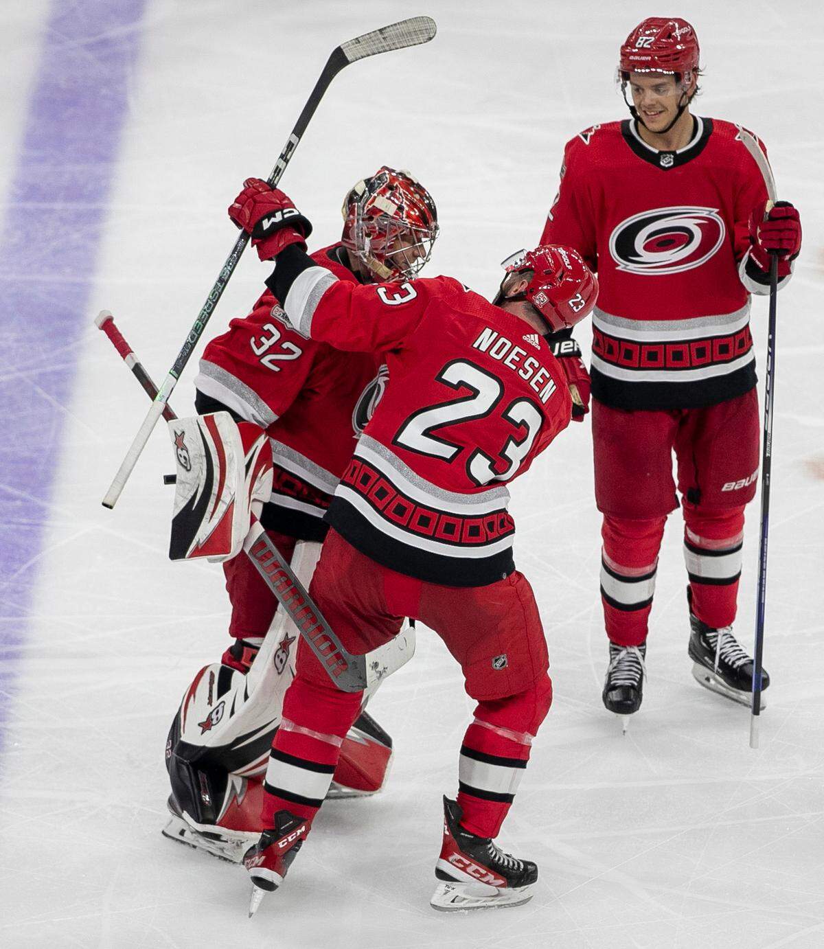 Carolina Hurricanes’ goalie Antii Raanta (32) is congratulated by teammate Stefan Noesen (23) after making 23 saves in the Hurricanes’ 4-3 victory victory over the New York Islanders on Wednesday, April 19, 2023 at PNC Arena in Raleigh, N.C.