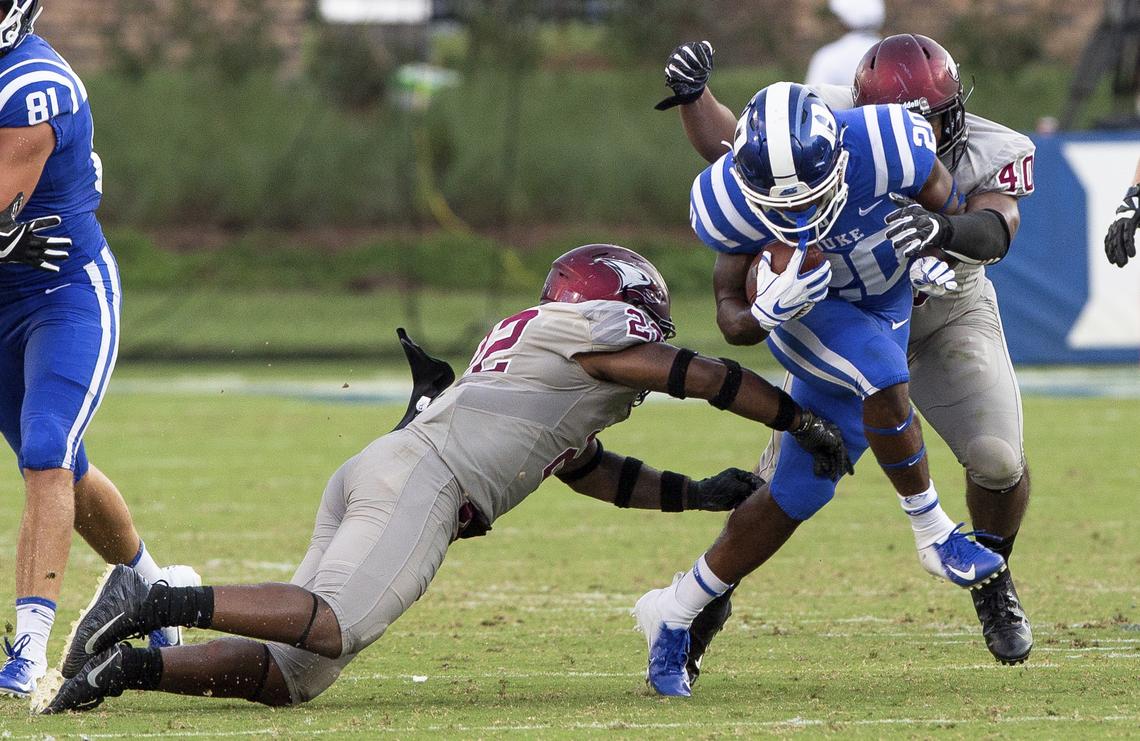 Duke’s Marvin Hubbard III, middle, carries the ball as N.C. Central’s Davanta Reynolds, left, and Patrick Connor, right, reach for a tackle in the Blue Devils’ 55-13 win over the Eagles on Saturday.